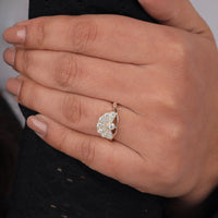 Close-up of a hand wearing a decorative ring with a leaf design, Round Cut Moissanite Vintage Ring, Unique Edwardian Fan Engagement Ring, 14K Gold Antique Inspired Moissanite Ring