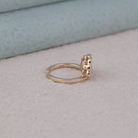 Gold ring with a diamond on a light gray surface, Edwardian Ring, Glamorous Vintage Moissanite Wedding Band, Heirloom Style Edwardian Engagement Jewelry.