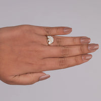 Hand wearing a diamond ring on a gray background, Sustainable Vintage Moissanite Ring, Dainty Milgrain Moissanite Engagement Ring