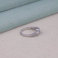 Silver ring with gemstones on a light skin tone surface, Three Stone CZ Engagement Ring, Sapphire Engagement Ring Vintage Style