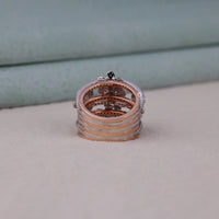 Stack of rose gold rings on a neutral background