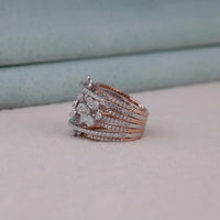 Stack of rose gold and silver rings on a light surface with a neutral background