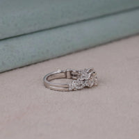 Silver ring with a diamond on a light pink surface, Vintage Inspired Princess Cut Moissanite Ring – Timeless Engagement & Bridal Ring