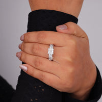 Hand wearing a diamond ring on a plain background, Princess Cut Moissanite Engagement Ring – Vintage Inspired Bridal Ring for Women