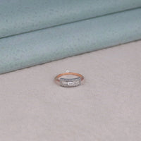 Silver ring with rose gold band on a light gray surface, Modern Moissanite Engagement Ring, Oval Moissanite Ring for Her