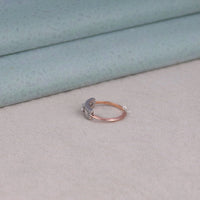 Jewelry ring with a small animal design on a textured surface, East West Setting Engagement Ring, Baguette Side Stone Ring