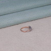 Rose gold ring with a moon design on a light gray surface, Minimalist Moissanite Ring