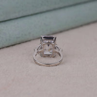 Silver ring with a rectangular gemstone on a light surface, Emerald & Tapered Baguette Cut CZ Three Stone Engagement Ring, Elegant Three Stone Wedding Ring For Women