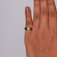 Hand wearing a green and gold ring with a diamond on a gray background, Elegant Green Emerald Baguette and Round CZ Ring, Cocktail Party Jewelry