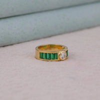 Gold ring with emeralds and a diamond on a light gray background, Emerald Cut CZ Bridal Jewelry, Gorgeous Round CZ Channel Set Wedding Band, Affordable Bezel Set CZ Engagement Ring
