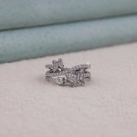 Silver ring with butterfly design on a soft surface