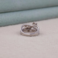 Stack of silver rings on a textured surface with a blurred background