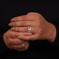 Close-up of hands with a diamond ring on a black background, Modern Pear and Baguette Moissanite Ring – Channel Set Bypass Design Jewelry