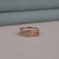 Rose gold ring with small diamonds on a soft surface