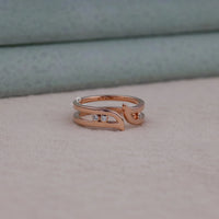 Rose gold ring with small diamonds on a soft surface
