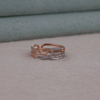 Two rose gold rings with diamond accents on a neutral background