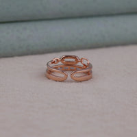 Rose gold ring on a soft surface with a neutral background