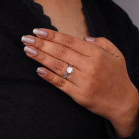 Hand wearing a diamond ring with a dark background, Vintage Style Milgrain Art Deco Filigree Round Moissanite Solitaire Engagement Ring