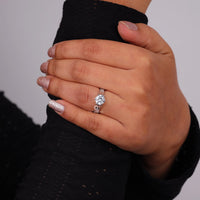 Hand wearing a diamond ring with a blurred background, Art Deco Vintage Moissanite Solitaire Ring, Milgrain Filigree Round Engagement Jewelry