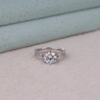 Silver diamond ring on a light surface with a neutral background, Milgrain Art Deco Round Moissanite Solitaire Ring, Vintage Filigree Wedding Jewelry