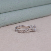 Silver ring with diamond on a light beige surface, Vintage Style Milgrain Art Deco Filigree Round Moissanite Solitaire Engagement Ring, Antique Inspired Bridal Jewelry