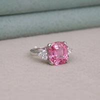 Ring with a pink gemstone on a light gray background