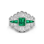 Elegant ring with emerald and diamond accents on a white background