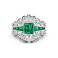 Elegant ring with emerald and diamond accents on a white background