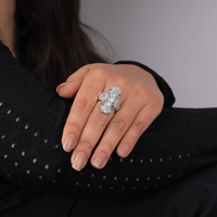 Hand wearing a diamond ring with a blurred background, 
Vintage Style Dinner Ring – Green Triangle & Round CZ with Milgrain Lozenge Design