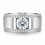 Silver ring with a large central diamond and smaller diamonds along the band on a white background