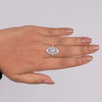 Silver ring with floral design on a hand against a gray background, Women’s Moissanite Wedding Jewelry, Sustainable Moissanite Ring