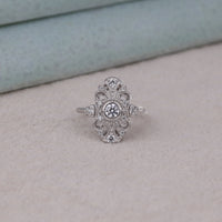 Silver ring with intricate design on a light gray surface,  Dainty Moissanite Ring, Navette Marquise Ring, Moissanite Promise Ring