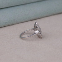 Silver ring with a diamond on a light gray surface, Fine Moissanite Jewelry for Women