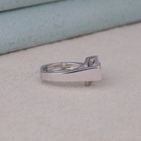 Silver ring with a diamond on a light gray surface, Contemporary Moissanite Engagement Band, Unique Moissanite Solitaire Ring, Sustainable Moissanite Engagement Jewelry