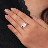 Silver ring with a diamond on a person's finger against a black lace background,  Moissanite Promise Ring, Moissanite Anniversary Ring, Round Moissanite Solitaire Band, Designer Moissanite Engagement Jewelry