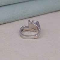 Silver ring with a clear gemstone on a light gray surface, Bypass Shank Moissanite Engagement Ring, Round Cut Moissanite Ring, Tension Set Moissanite Ring, Channel Setting Moissanite Ring, Modern Moissanite Engagement Ring, Floating Stone Moissanite Ring