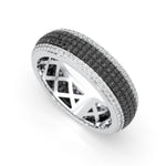 Silver ring with black and white gemstones on a white background