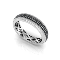 Silver ring with black and white gemstones on a white background