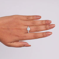 Hand wearing a diamond ring on a light gray background, lab created moissanite wedding ring, moissanite multi stone band ring, moissanite bridal jewelry gift