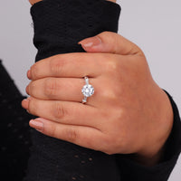 Hand wearing a diamond ring on a neutral background, moissanite anniversary ring for women, moissanite bridal ring set, round moissanite eternity style ring