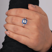 Silver ring with a blue gemstone on a hand against a gray background, asscher sapphire baguette wedding band, art deco sapphire bridal ring, vintage style sapphire engagement ring