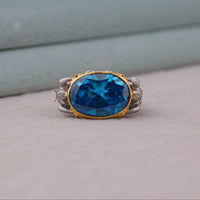 Ring with a blue gemstone and gold and silver band on a neutral background, Aqua Man Fan Merchandise Ring, Durable Cocktail Ring For Men And Women, Funky Ocean God Greek Mythology Jewelry