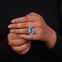 Hand wearing a ring with a blue gemstone on a black background, Superhero Comic Fan Ring, Bold Poseidon Greek God Jewelry