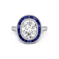 Diamond ring with blue gemstones on a white background