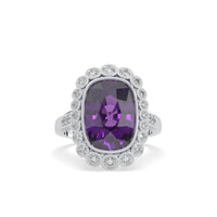 Ring with a purple gemstone and diamond-studded band on a white background