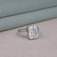 Silver ring with a large diamond on a soft surface