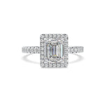 Diamond ring with emerald-cut center stone on a white background