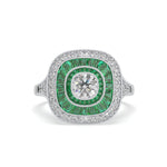 Ring with green gemstone and diamond on a white background