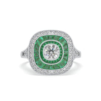 Ring with green gemstone and diamond on a white background