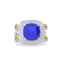 Ring with a blue gemstone and yellow gemstones on a white background